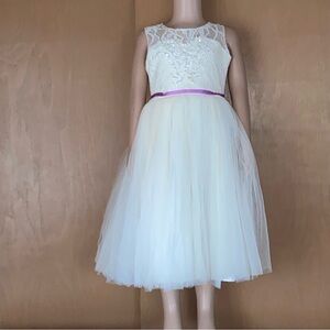 Custom made flower girl dress of white lace and organza. Lavender ribbon tie.